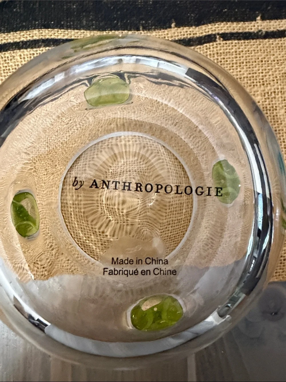 Anthropologie Clear drinking glass with yellow/green tennis ball accents.